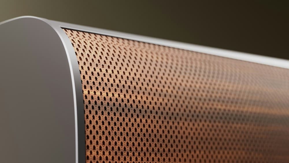 Close-up of the perforated metal grille of a soundbar