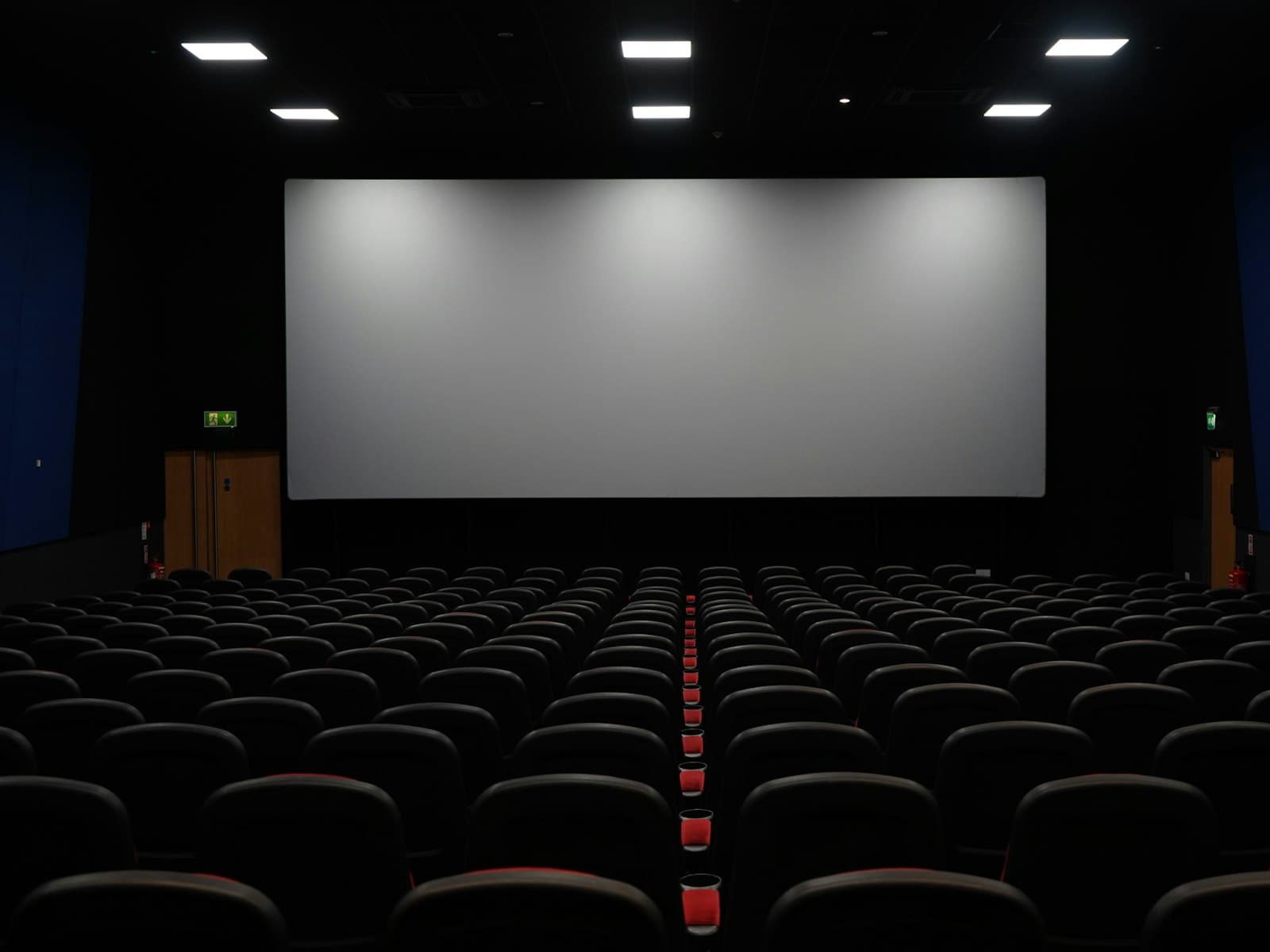 Aurea P700 projector on its tilting stand, dark housing with a large lens
